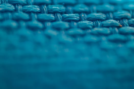 a macro shoot of braided blue cloth texture. focus on top side of picture.