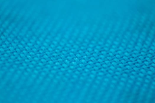 a macro shoot of swollen blue cloth texture. focus on mid of shoot.