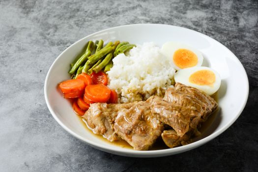 Baked pork ribs with rice, boiled egg and vegetable