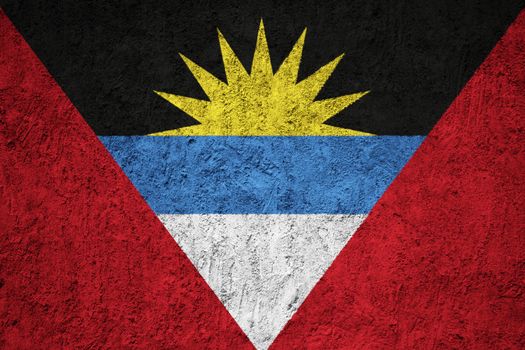 Antigua and Barbuda flag painted on the cracked grunge concrete wall