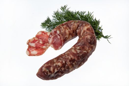 Sausage and greenery on an isolated studio background