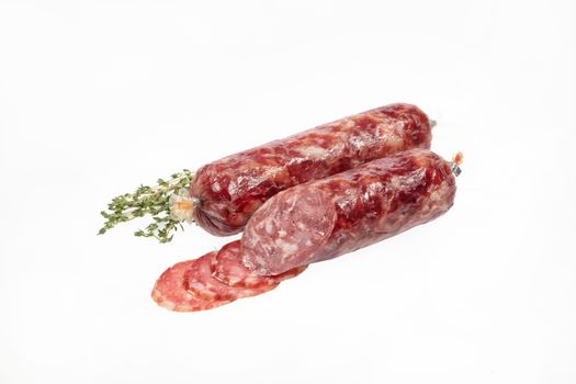 Sausage and greenery on an isolated studio background