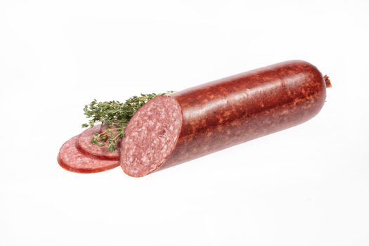 Sausage and greenery on an isolated studio background