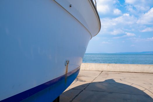 Boats are on the boat station on the pavement.