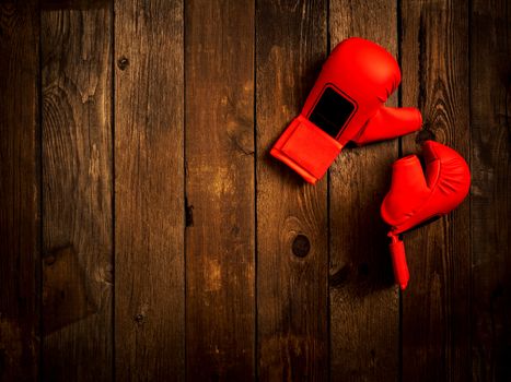 Pair of leather karate gloves lying on the wooden table