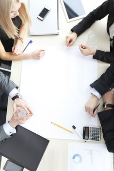 Business people sitting at table with electronic devices on meeting