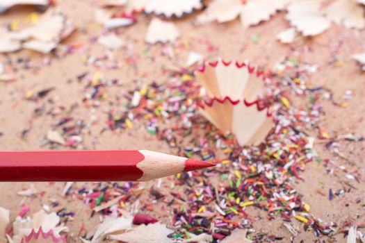 Red Color Pencil over some  pencil shavings