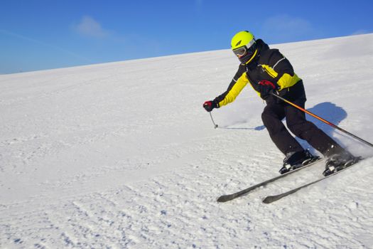 Skier skiing downhill in high mountains at Bolchoi Voudyavr, Kirovsk, Murmansk Oblast, Russia