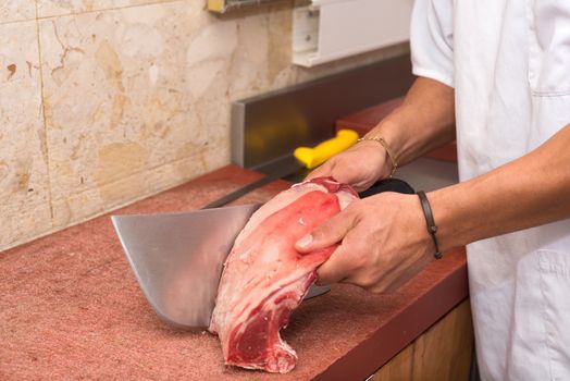 butcher cutting steaks at the butcher shop