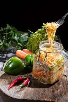 Cabbage and vegetables on an old wooden background