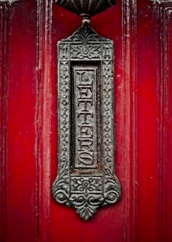 Ornate Old Fashioned British Letterbox Or Mailbox On A Red Front Door