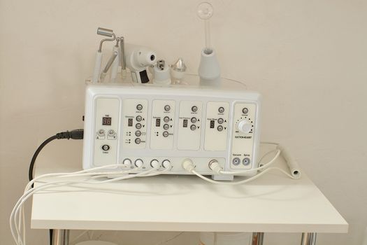 Cosmetic Multifunctional Device close-up in beauty salon. Ultrasound medical device. Darsonval device. Ultrasound procedure. Medical equipment healthcare. Young skin. Face professional massage.