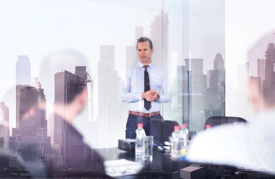 Corporate business, economic development or real estate company concept. Confident company leader on business meeting against new york city manhattan buildings and skyscrapers window reflections.