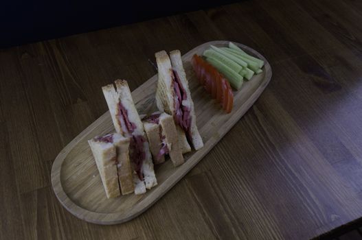 sliced cheddar and sausage toast cucumber tomato prepared for breakfast