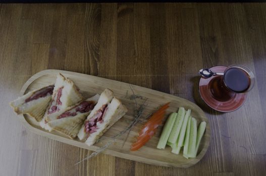 sliced cheddar and sausage toast cucumber tomato tea prepared for breakfast