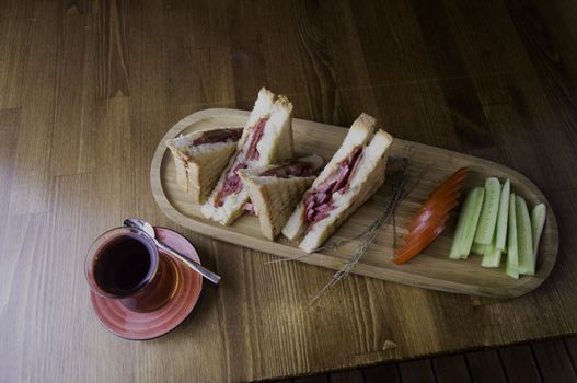 sliced cheddar and sausage toast cucumber tomato tea prepared for breakfast