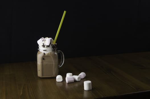 Candy flavoring with chocolate drinks in glass cups with handles placed