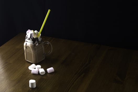 Candy flavoring with chocolate drinks in glass cups with handles placed