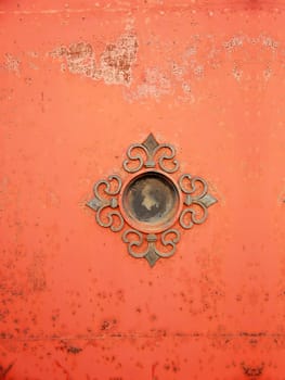 Grunge small window in old iron painted door.