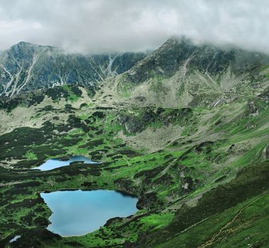 Highest part of Tatra mountains. Below "Five lakes valley". National park area. Summer time, cloudy sky. Wide angle panoramic view.