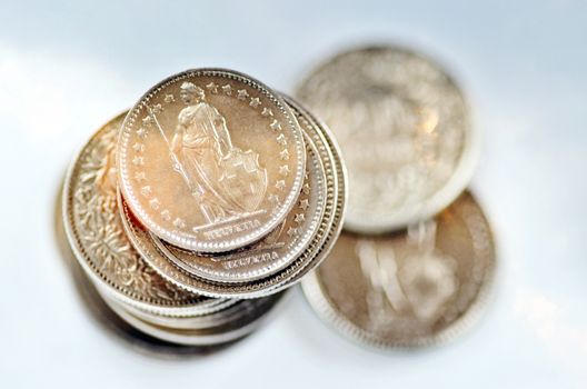 Stack of Swiss Franc coins over white background.