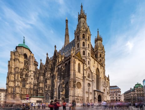 Crowd of tourist travel in shopping street in center of Vienna with Domkriche St. Stephan, famous travel location, church in Vienna, Austria, Europe