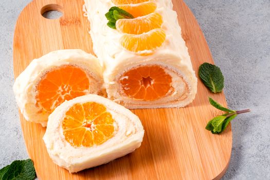 Sweet cake roll with whipped cream and tangerine filling.