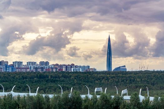 Evening cityscape. View of the Lakhta Center tower in St. Petersburg with dramatic clouds.