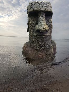 Ancient ruins Mayan head on the beach at the Baltic Sea