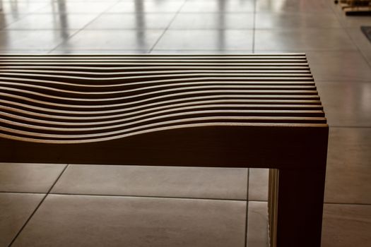 a closeup perspective shoot of a wood seat. photo has taken at an university.