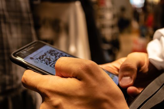 a man holding smartphone and checking something. an isolated concept shoot.