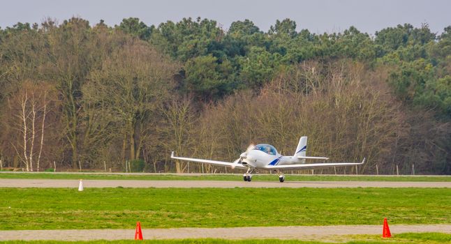 white stunt airplane taking off, recreational air transportation