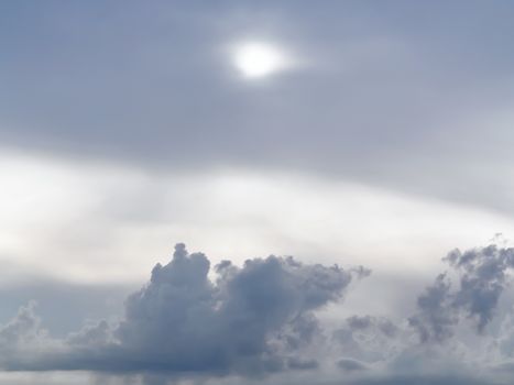 Sun shines through the overcast sky in cloudy weather - image, photo.