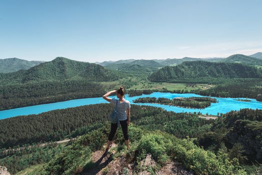 Woman taking photo on mobile phone at the mountain peak.