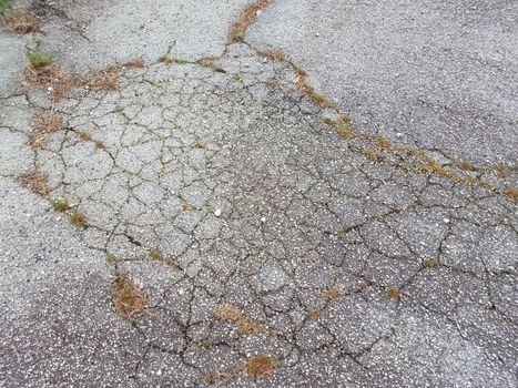 damaged or weathered or worn black asphalt road or street