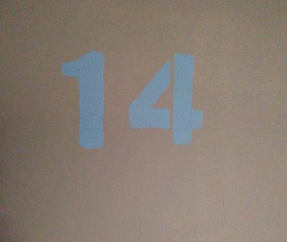 The number 14 painted with blue paint on a pink background. Symbol.