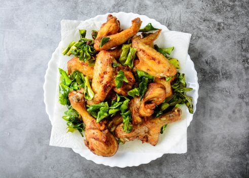 Fried crispy chicken wings, Thigh on white plate with herbs