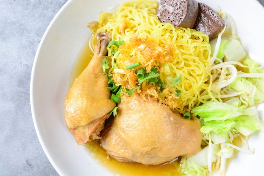 a plate of chicken and noodles soup with vegetables