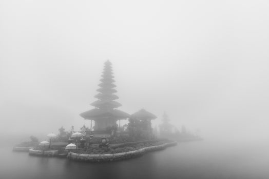 Foggy weather at Pura Ulun Danu Beratan temple in Bali, Indonesia. Black and white photo.