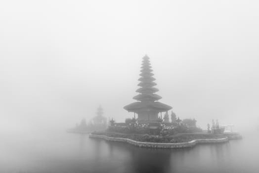 Foggy weather at Pura Ulun Danu Beratan temple in Bali, Indonesia. Black and white photo.