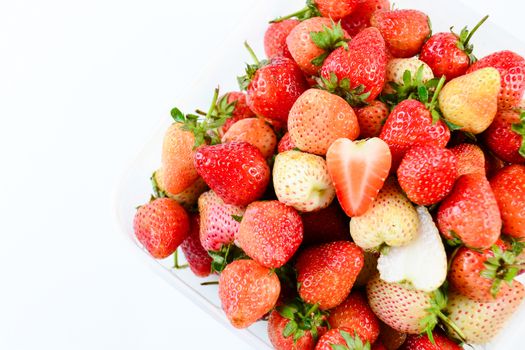 Fresh strawberries in white transparant box on white background