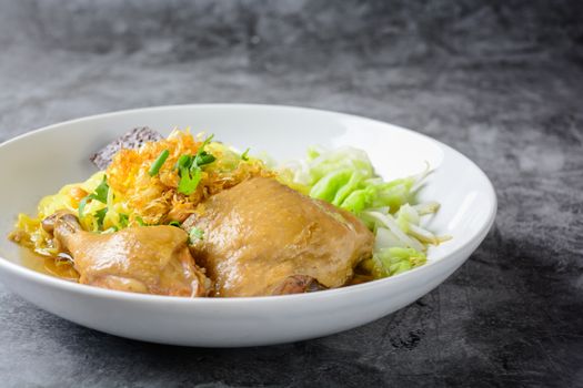 a plate of chicken and noodles soup with vegetables