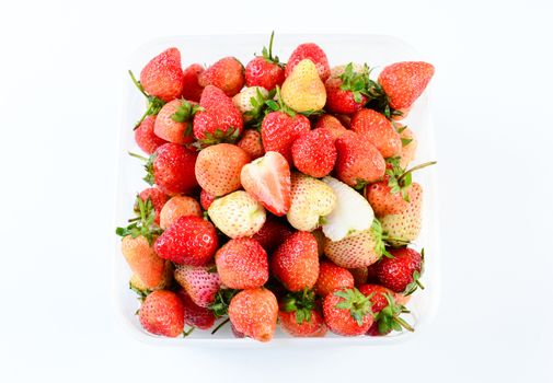 Fresh strawberries in white transparant box on white background