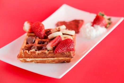 Strawberry and Banana flavour waffle with whipped cream and chocolate spread