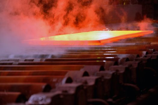 Industrial hot steel coil on conveyor
