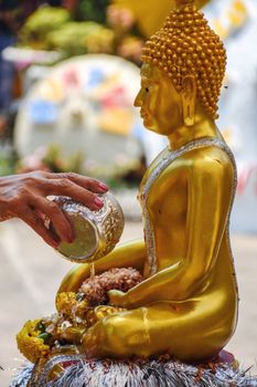 Bathing the Buddha image on Songkran Day in Thailand.