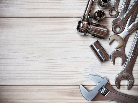 Several spanners on wooden board. Copy space. Construction concept