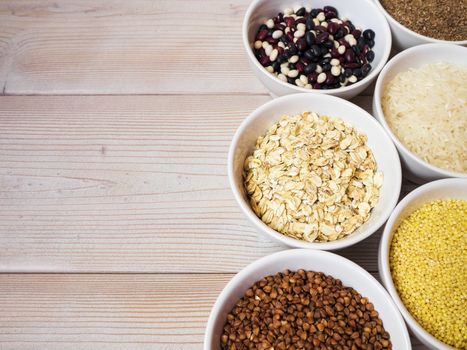 Cereals and grains in ceramic bowls standing on the table