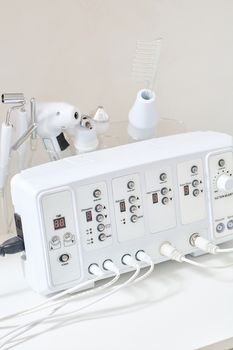 Cosmetic Multifunctional Device close-up in beauty salon. Ultrasound medical device. Darsonval device. Ultrasound procedure. Medical equipment healthcare. Young skin. Face professional massage.