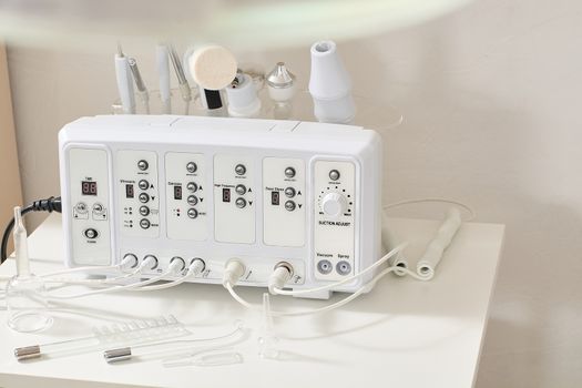 Cosmetic Multifunctional Device close-up in beauty salon. Ultrasound medical device. Darsonval device. Ultrasound procedure. Medical equipment healthcare. Young skin. Face professional massage.